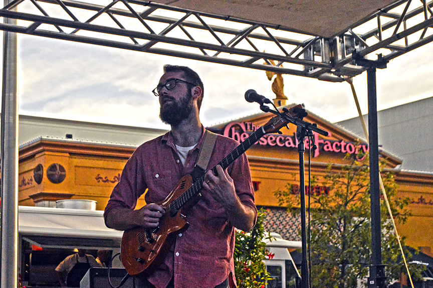 Guitarist stroking chords at Mac and Cheese Fest