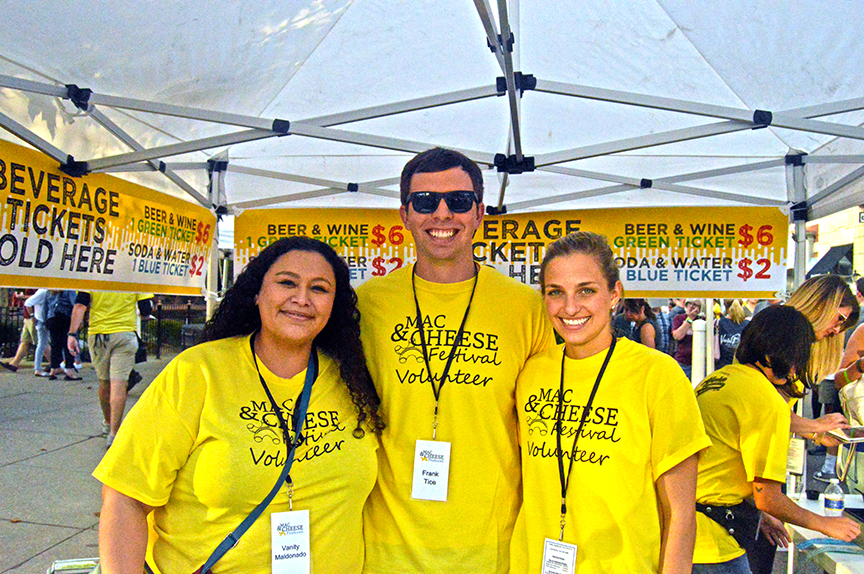 Three ambassadors in yellow shirts at festival